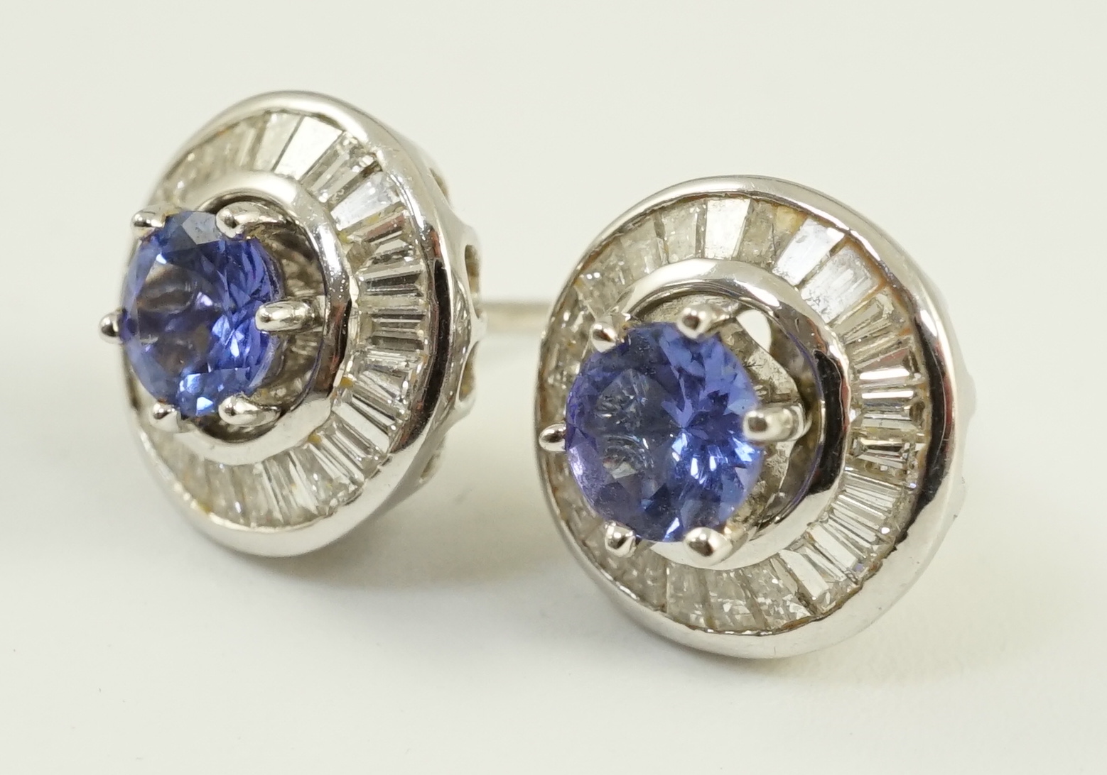 A modern pair of 750 white gold, tanzanite and diamond cluster set earrings